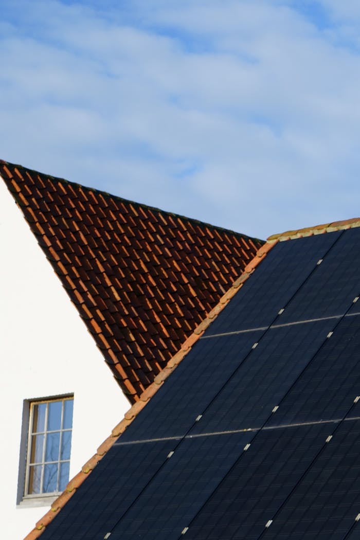 About Close-up of solar panels and a tiled roof, showcasing renewable energy solutions in architecture.