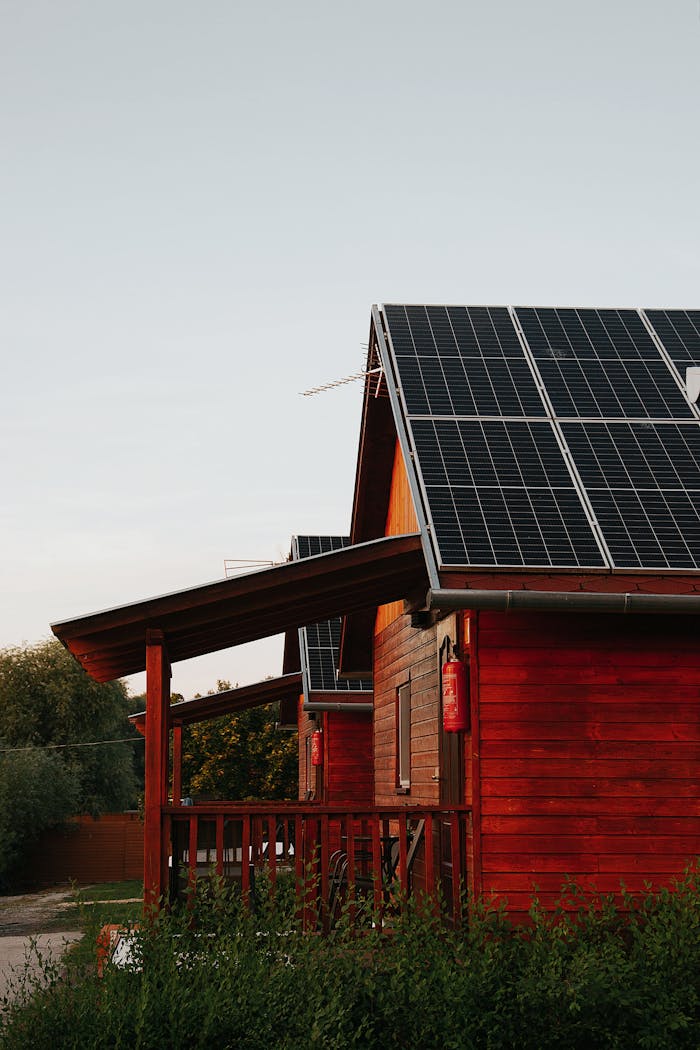 Home Wooden house featuring solar panels, captured at sunset, highlighting eco-friendly architecture.